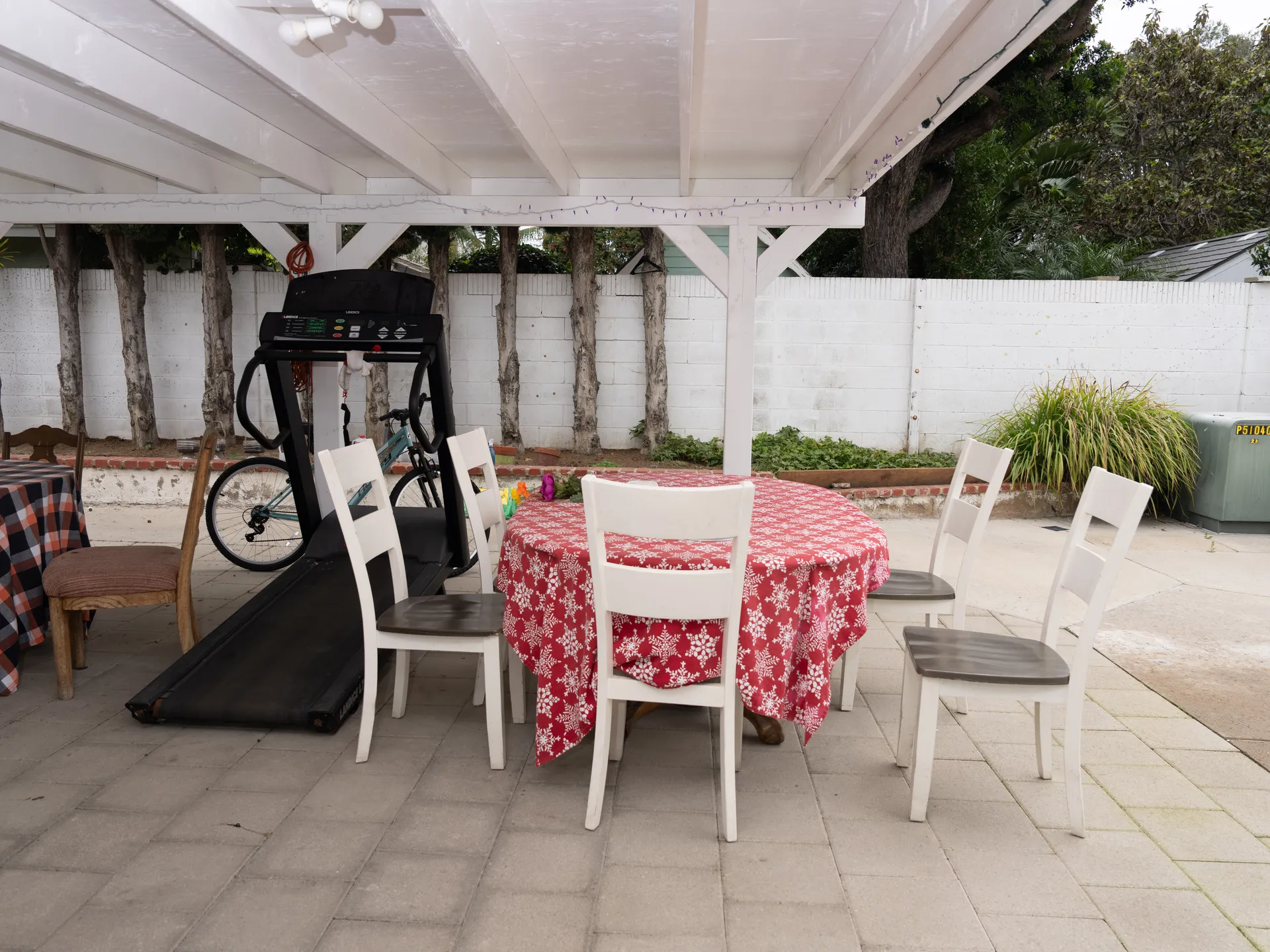 Accessible covered patio with dining area and exercise equipment at residential care facility